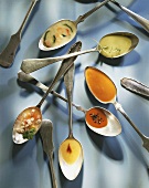 Different soups on spoons