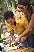 Couple preparing barbecued courgette strips