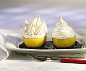 Baked apples with meringue topping in elderberry sauce