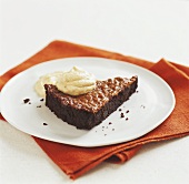Piece of chocolate almond cake with caramel and almond cream