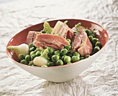 Cured pork with peas and spring onions