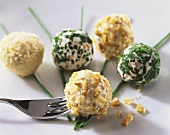 Soft cheese balls with nuts, herbs and sesame