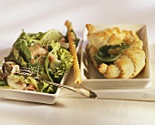 Salad leaves with fish and croissant filled with rocket