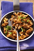 Fried chanterelles with chives in frying pan