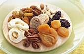 Nuts and dried fruit on wooden plate