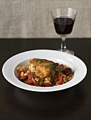 Risotto with chicken, peppers and chorizo, glass of red wine