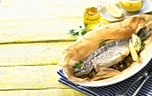 Stuffed trout with lemon in baking parchment