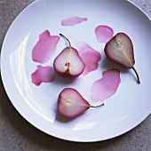 Poached pears with red wine sauce on plate
