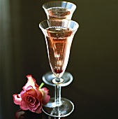 Two glasses of Kir Royal, a rose beside them