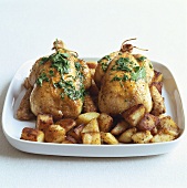 Two poussins (spring chickens) with roast potatoes