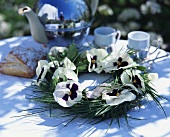 Spring table decoration: wreath of pansies