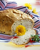 White bread with edible flowers, a slice cut
