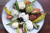 Plate of Mediterranean appetisers: dips and vegetables