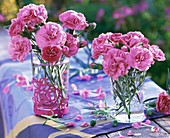 Small posies of pinks in glasses