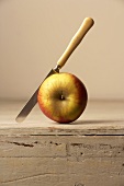 Fresh apple with knife