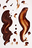Chocolate sauce smeared on white background