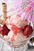 Strawberry ice cream, strawberries, wafer rolls, cocktail umbrella
