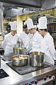 Four chefs checking cooked vegetables