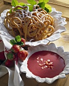 Spritzkrapfen (fried piped pastry) with strawberry sauce (Austria)