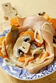 Pig's ear stuffed with mushrooms, carrots and onions