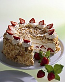 Cream cake with chopped nuts and strawberries