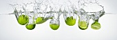Limes falling into water