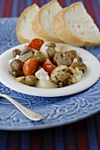 Fried mushrooms with olives, tomatoes and feta