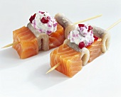 Salmon and matjes herring on two cocktail sticks