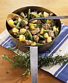 Lamb, potatoes and green beans in copper pan