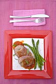 Pork with tomato sauce and green asparagus