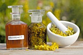 St. John's wort oil with ingredients and mortar & pestle