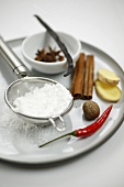 Icing sugar in sieve and various spices for gingerbread