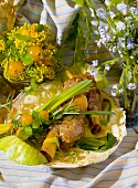 Veal shanks with vegetables, surrounded by spring flowers