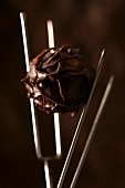 Chocolate truffle on dipping forks