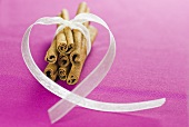 Cinnamon sticks with heart-shaped ribbon
