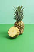 Whole pineapple and half a pineapple