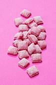 Red wine lozenges on pink background