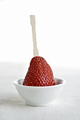 Fresh strawberry with small wooden fork