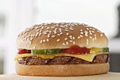 Cheeseburger with ketchup, mustard and gherkin