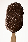 Chocolate-coated ice cream with almonds on a stick
