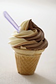 Chocolate and vanilla soft ice cream in cone