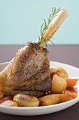 Roast leg of lamb with rosemary, potatoes and carrots