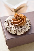 Espresso biscuit with caramel rosette on a brown box