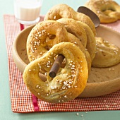 Soft pretzels on the handle of a wooden spoon