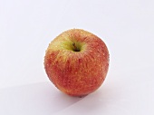 A Gala apple with drops of water
