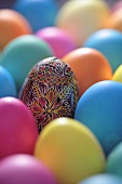 Coloured Easter eggs and one painted egg