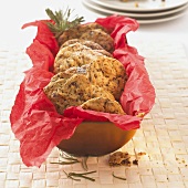 Christmas cookies on red paper in cake tin (USA)