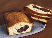 Walnut loaf cake with chocolate, partly sliced