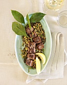 Beef fillet kebabs on lentils