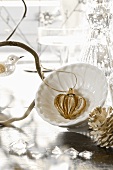 Christmas decoration: gold and silver heart in dish